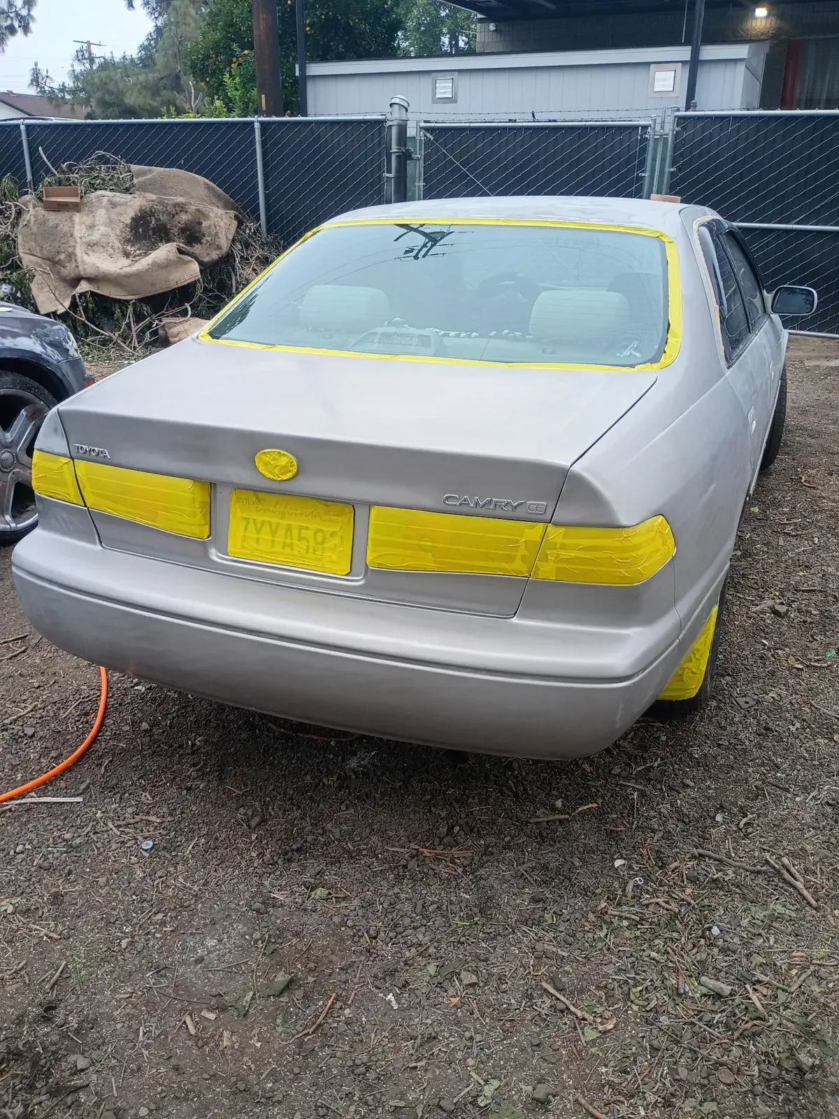 Maroon pickup masked off in the shop and prepped for paint