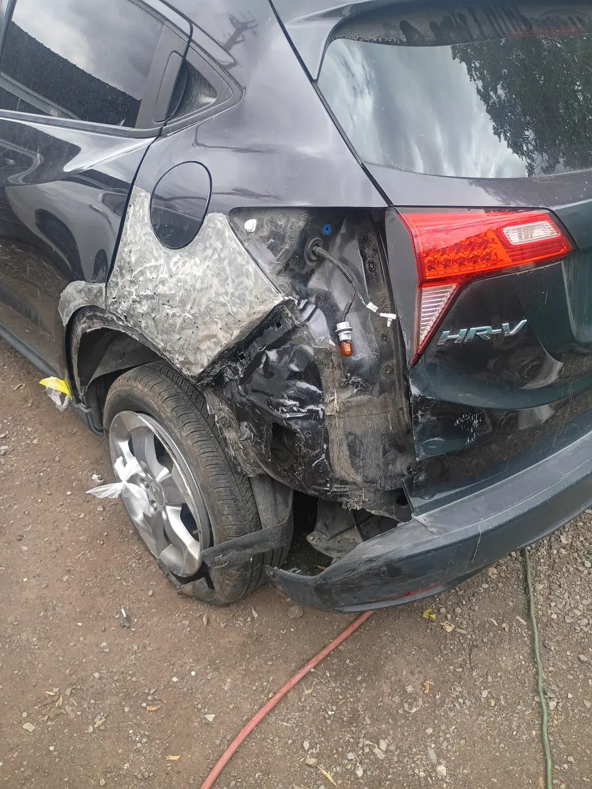 Honda HR-V wrecked behind the rear wheel before collision repair